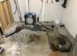 basement floor opened to install sewage ejector pump and underground plumbing