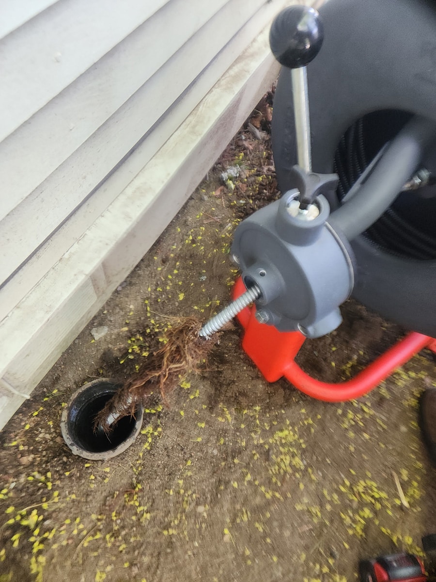 cda-main-line-root-removal cable machine pulling roots from main sewer line cleanout in Coeur d’Alene