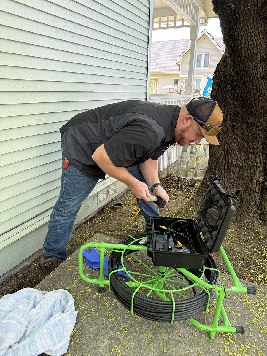 cda-sewer-camera-inspection-after-root-removal plumber using sewer camera equipment after clearing roots from main line in Coeur d’Alene