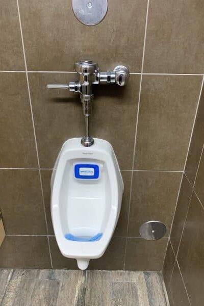 urinal fixture after cleaning and repair with restored proper drainage