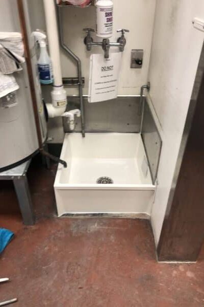 commercial mop sink installed in utility room at gas station