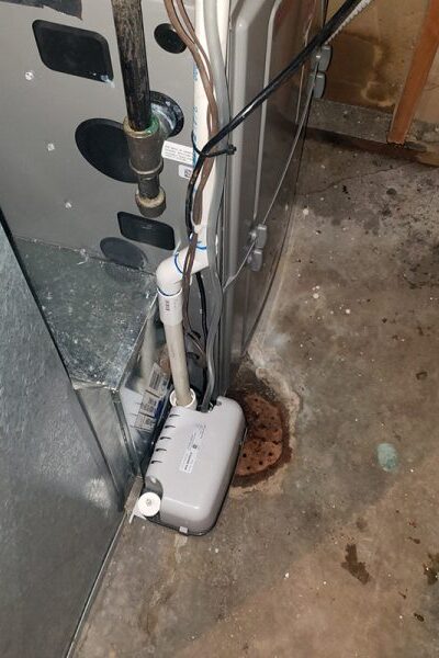 condensate pump installed to reroute drain line and prevent pipe corrosion