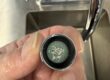dirty faucet aerator clogged with debris and mineral buildup
