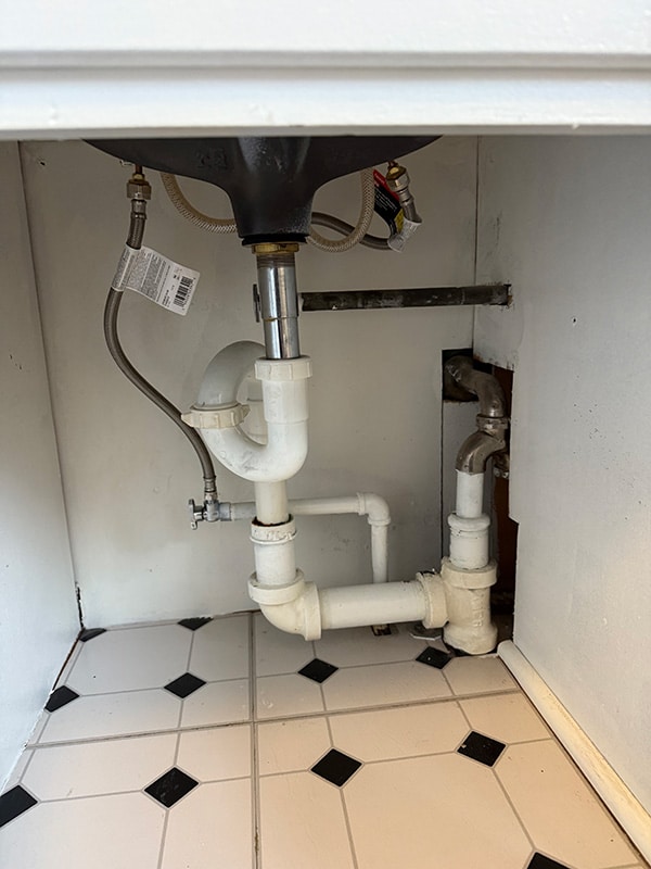 Existing under-sink plumbing before drain replacement in Spokane home