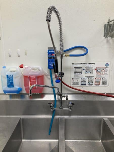Fisher commercial faucet with pull down sprayer installed at kitchen sink with sanitizer connection