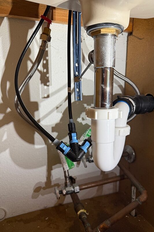 Chrome plated brass pop up bathroom sink drain installed under vanity in Hayden Idaho