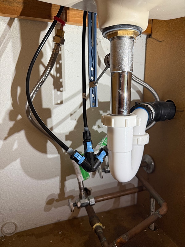 Chrome plated brass pop up bathroom sink drain installed under vanity in Hayden Idaho