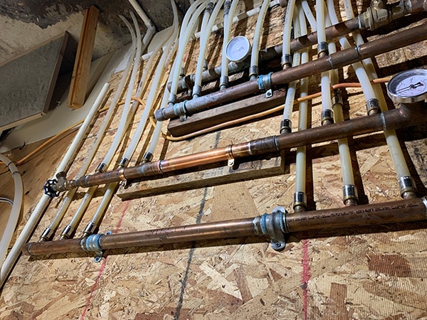 repaired hydronic heating manifold with new type L copper section installed