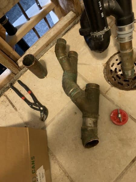 leaking-copper-drain-pipe-spokane-valley old copper drain pipe with visible corrosion and leak in residential plumbing system