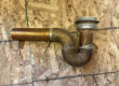 old copper shower trap and drain removed during Post Falls bathroom remodel
