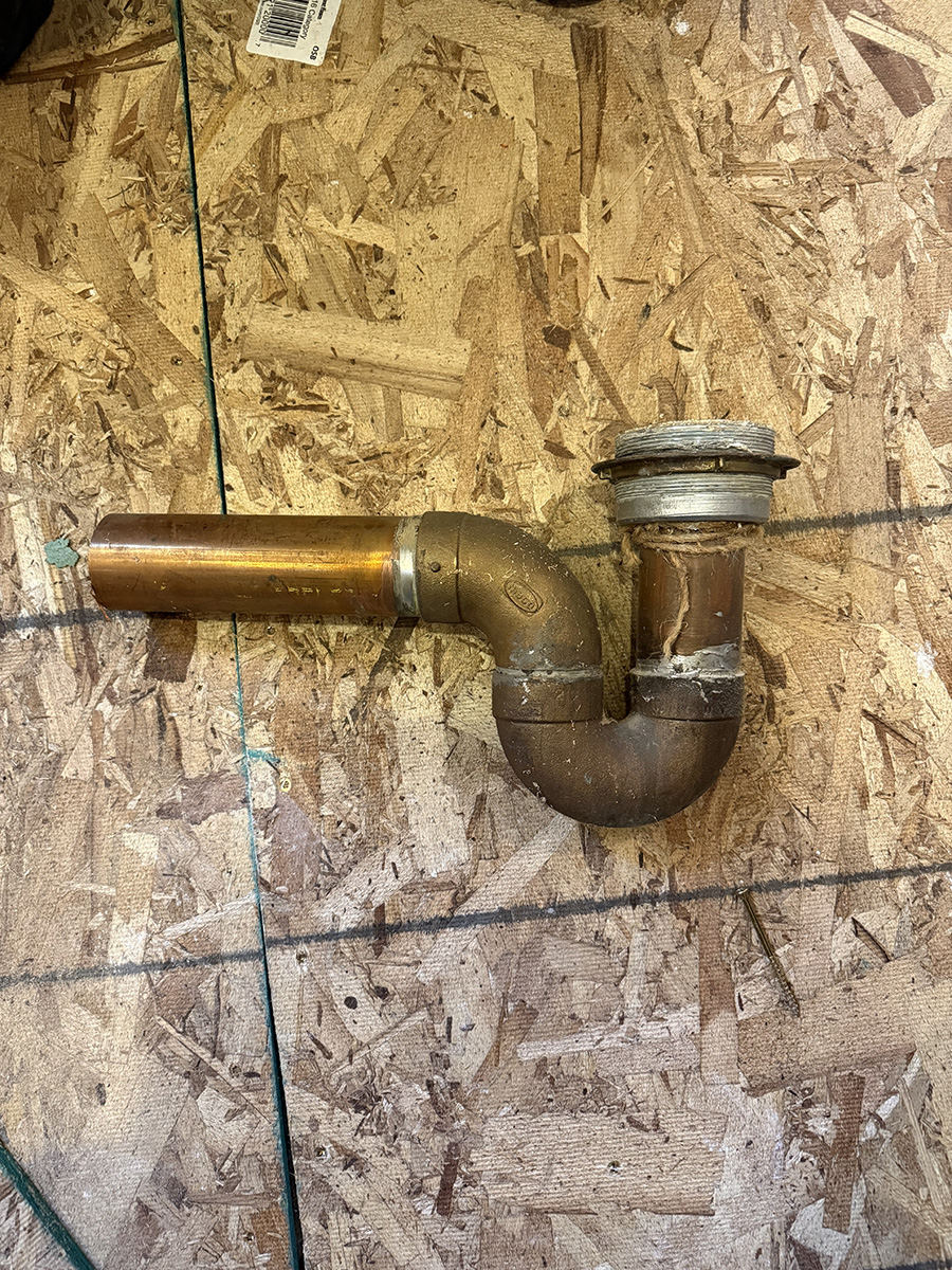 old-copper-shower-drain-post-falls old copper shower trap and drain removed during Post Falls bathroom remodel