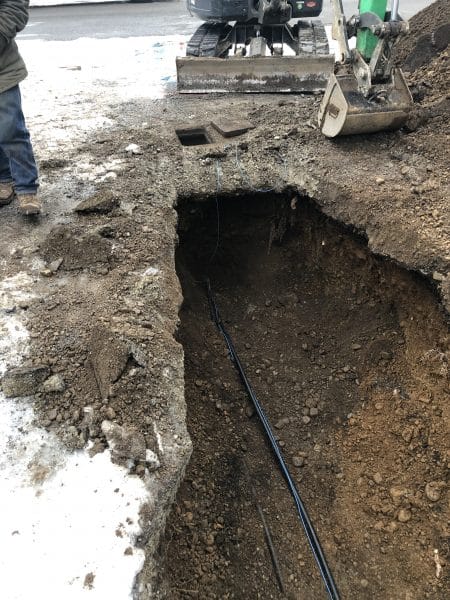 underground water main exposed in trench during low water pressure repair