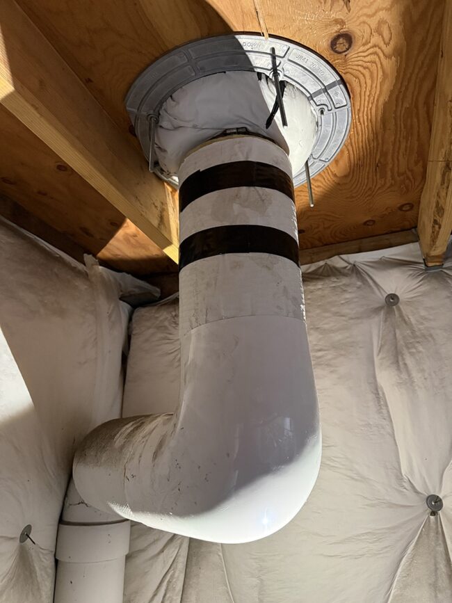 close view of roof drain pipe connection band inspected after leaking