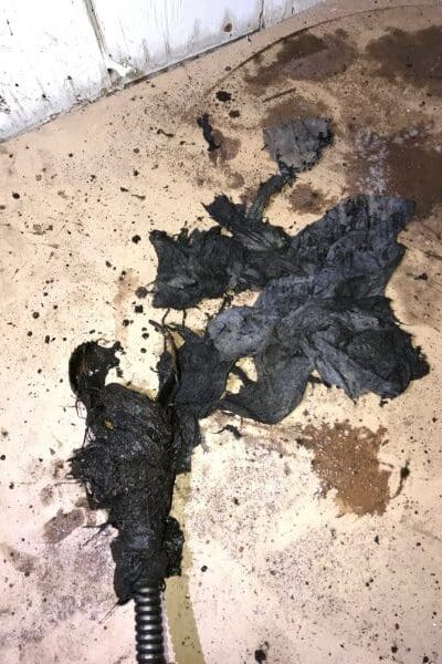 debris removed from clogged sewer line using cable machine in Spokane