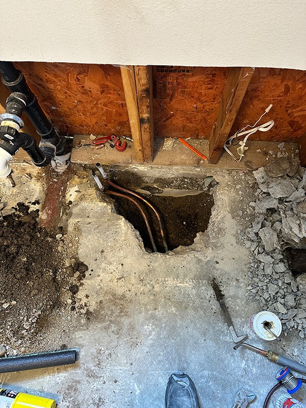 Slab leak detection in Rathdrum showing exposed copper water lines under concrete floor Slab leak detection in Rathdrum showing exposed copper water lines under concrete floor