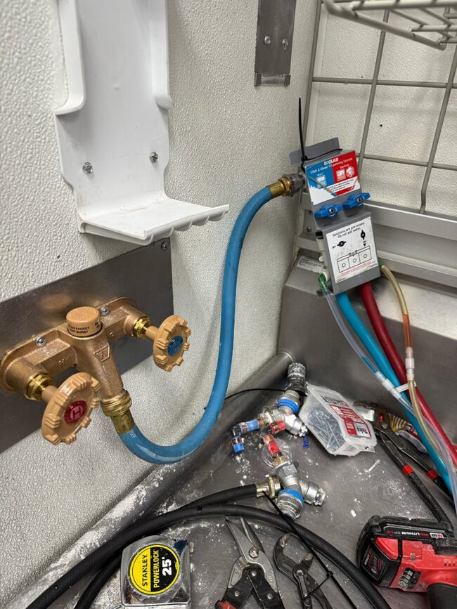 Properly mounted stainless steel commercial hot and cold hose bib