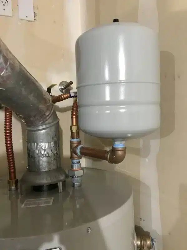 properly installed expansion tank on water heater showing separation from copper piping