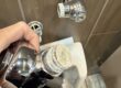 automatic urinal flush valve showing improper sealant applied to threaded connection
