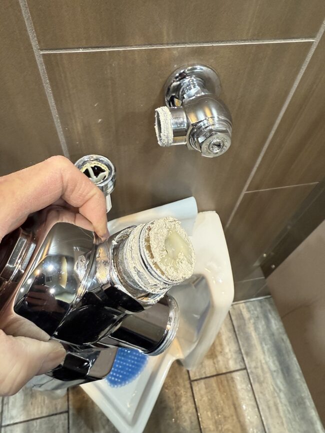 urinal-flush-valve-installation-error automatic urinal flush valve showing improper sealant applied to threaded connection