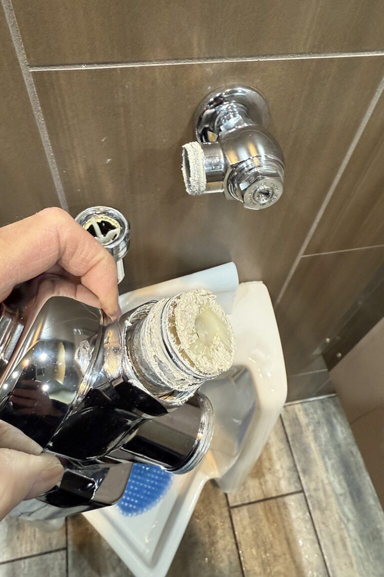automatic urinal flush valve showing improper sealant applied to threaded connection