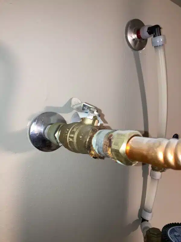 close up of corroded plumbing connection near water heater showing damage from electrolysis
